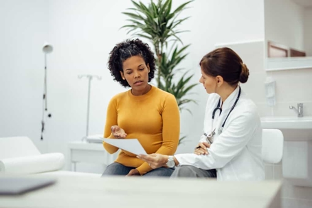 Patient talks with her doctor in an exam room
