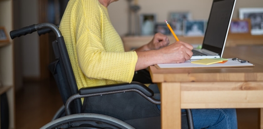 disabled person completing paperwork