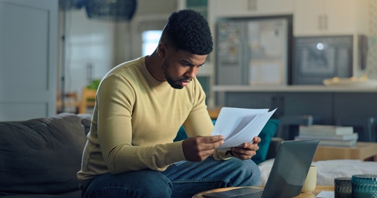 person reading documents at home